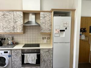 a kitchen with a white refrigerator and a stove at City Centre 1 in Manchester