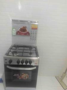 a stove top oven in a white kitchen at غرفتين بدخول ذاتي in Al Kharj