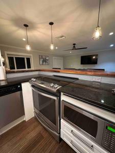 a large kitchen with stainless steel appliances in it at New Beach Cabana with Mini Golf in Venice