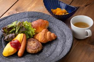 a plate of food on a table with a cup of coffee at HOTEL MYSTAYS Fukuoka Tenjin in Fukuoka +31 photos