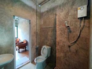 a bathroom with a shower and a toilet and a sink at innbox Chiangmai Hotel in Ban Si Ngam