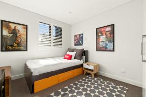 a small bedroom with a bed and a window at 4 bedrooms family home in Bronte in Sydney