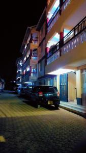 a car parked in front of a building at night at Nabbynates bnbs in Eldoret