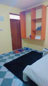 a bedroom with a bed and a tiled floor at Nabbynates bnbs in Eldoret