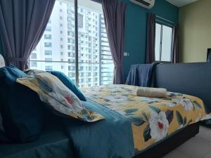 a bedroom with a bed with a floral comforter and a window at Great Escape by SM Retreats in Cyberjaya +33 photos