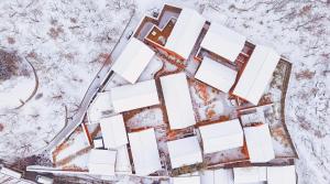 an aerial view of a building in the snow at Sansa Village Boutique Hotel at Mutianyu Great Wall in Huairou