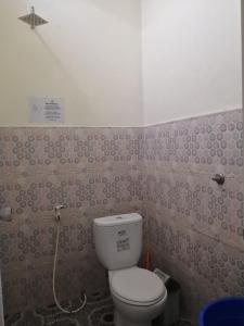 a small bathroom with a toilet and a shower at Ocean house karimunjawa in Karimunjawa