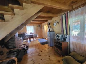 a kitchen and dining room in a log home at Miejsce w lesie 