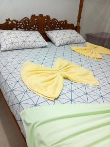a bed with two yellow towels on it at Brave resort Mirissa in Mirissa
