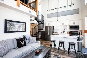 a living room with a couch and a kitchen at Mountain View Chalet at The Quarry - Sleeps 6! in Whitefish