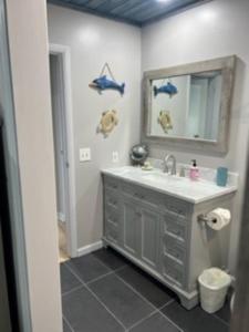 a bathroom with a sink and a mirror at Harbor Island D112 in Oceanmarsh Subdivision