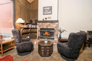 a living room with two chairs and a fireplace at Broomall at Snow Summit Ski Resort in Big Bear Lake