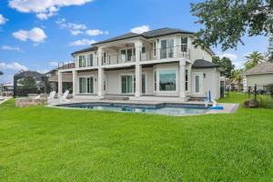 a large house with a swimming pool in the yard at Chateau Coquina in Jacksonville
