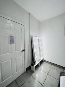 a white room with a door and a mirror at CASA AMBAR in Tijuana