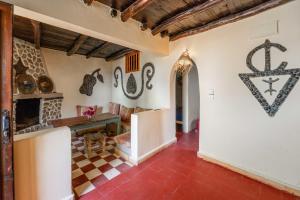 a room with a table and some items on the wall at Dar Afoulky Maison D'hotes in Sidi Kaouki