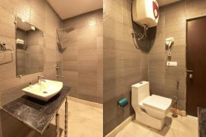 a bathroom with a toilet and a sink at Luxury Tashree Hotel at Airport in New Delhi