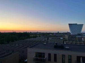 a view of a city at sunset with a building at Fully equipped apartment, 15 min to Center in Copenhagen