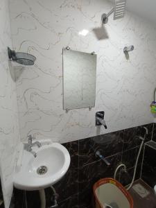 a bathroom with a sink and a mirror on the wall at Hotel Powai Residency in Mumbai