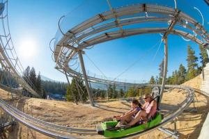 two people riding a roller coaster at an amusement park at Storybook Cottage Near Slopes in Big Bear Lake