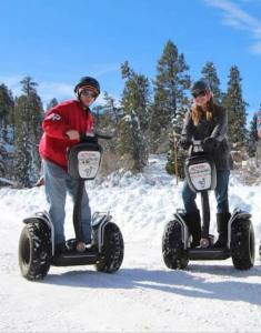 two people are riding on segifts in the snow at Storybook Cottage Near Slopes in Big Bear Lake