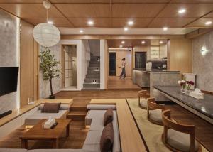 a living room with a couch and a table at Yama Onsen Villa in Bandung