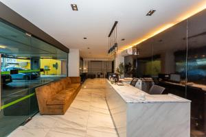 a lobby with a long counter and a couch at Infinite Hotel-Ratchada in Bangkok