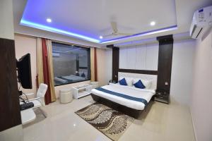 a bedroom with a bed and a television in it at Hotel Himalaya in Bongaigaon