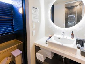 a bathroom with a sink and a mirror at Rakuten STAY Nikko Hoden in Nikko +40 photos