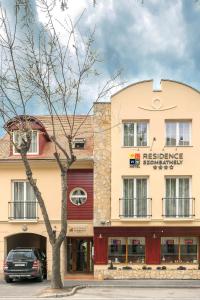 a car parked in front of a building at P4W Hotel Residence Szombathely in Szombathely