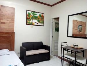 a room with a bed and a table and a chair at Mariella's Guest House in Siquijor
