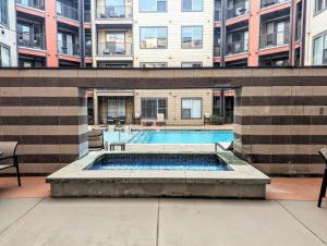 a swimming pool in front of a building at League Flats South End at South Blvd in Charlotte