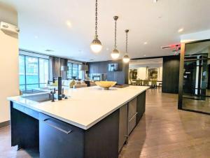 a large kitchen with a large island in the middle at League Flats South End at South Blvd in Charlotte