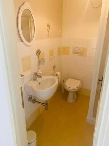 a bathroom with a sink and a toilet at La Fabbrica Delle Idee B&B in Fonte