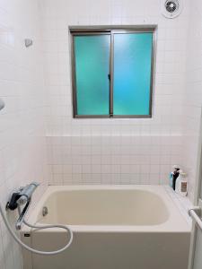 a white bath tub with a window in a bathroom at Cate no mori - Vacation STAY 30749v in Shime