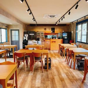 a dining room with wooden tables and chairs at Cate no mori - Vacation STAY 30749v in Shime