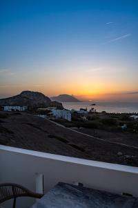 a view of the sunset from the balcony of a house at Arkasa Palace in Arkasa
