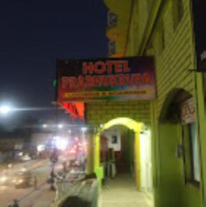 un panneau d'hôtel sur le côté d'un bâtiment la nuit dans l'établissement Hotel Prabhu Krupa, Bhubaneswar, à Bhubaneswar