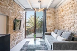 a living room with a couch and a large window at Athali Villa in Krousón +40 photos
