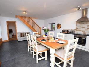 a kitchen and dining room with a wooden table and chairs at 2 bed property in Nidderdale HH011 
