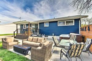 a blue house with a patio with furniture at Sleek Great Falls Retreat in Great Falls