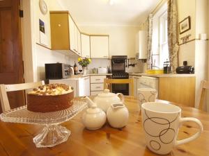 a kitchen with a table with a cake on it at 2 bed property in Wooler Northumberland CN226 in Wooler