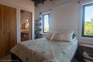 a bedroom with a bed with two pillows on it at La Vida Belize - Casa in Riversdale