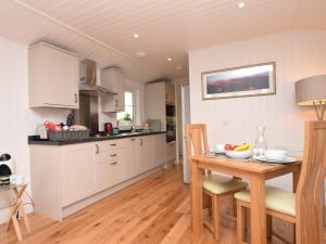 a kitchen with a table with a bowl of fruit on it at 1 Bed in Langbank 73846 in Langbank