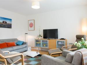 a living room with couches and a flat screen tv at 3 Bed in Camber BT044 in Camber