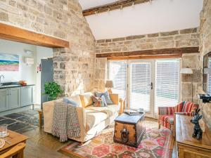 a living room with a stone wall at 2 Bed in North York Moors National Park G0132 in Rosedale Abbey