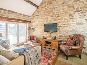 a living room with a stone wall at 2 Bed in North York Moors National Park G0132 in Rosedale Abbey