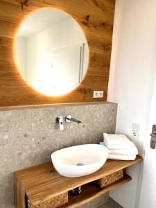 a bathroom with a sink and a mirror at Ferienwohnung Spiemont in Sankt Wendel