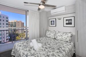 a bedroom with a bed and a large window at Syrenuse 22 in Mooloolaba