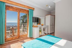 a bedroom with a bed and a large window at Ölüdeniz Manzara Non Alcoholic Family Hotel in Oludeniz