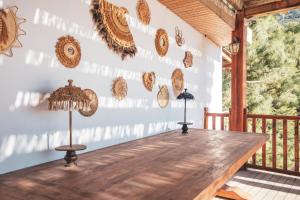 een houten tafel op de veranda van een huis bij Ölüdeniz Manzara Non Alcoholic Family Hotel in Oludeniz